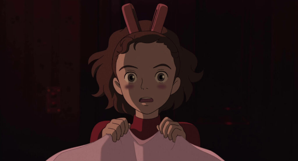 Arrietty with wide eyes holding cloth in dim light surprised anime scene wallpaper background