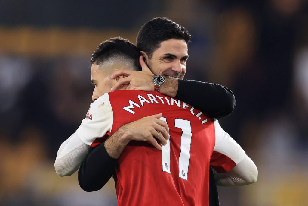 Arsenal FC manager Mikel Arteta joyfully embraces Gabriel Martinelli in red white kit wallpaper