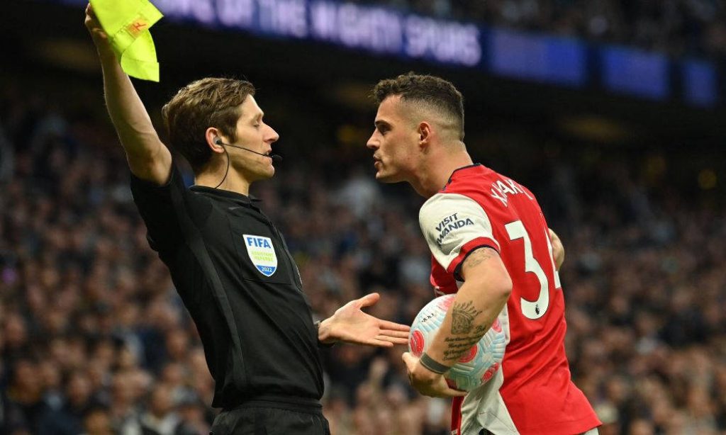 Arsenal Granit Xhaka confronts FIFA assistant referee intense football stadium wallpaper background