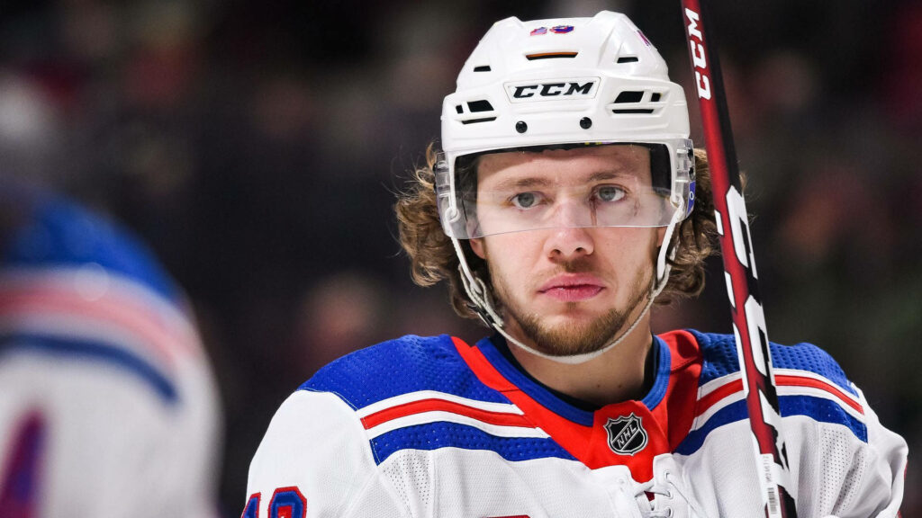 Artemi Panarin in hockey gear on ice showing intense focus and calm presence wallpaper