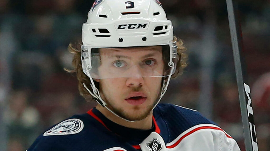 Artemi Panarin focused on ice hockey rink intense determination high resolution wallpaper background
