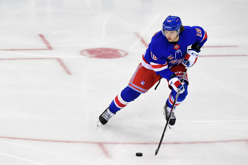 Artemi Panarin skating with puck in New York Rangers uniform dynamic hockey wallpaper