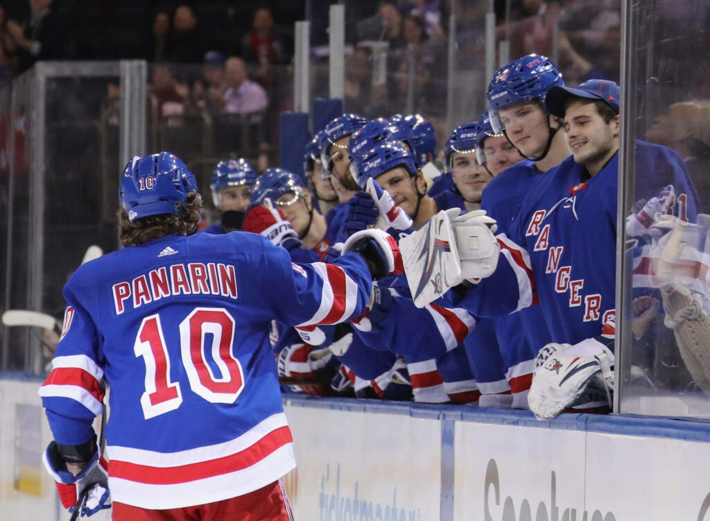 Artemi Panarin Waves to Teammates in Dynamic Rangers Wallpaper