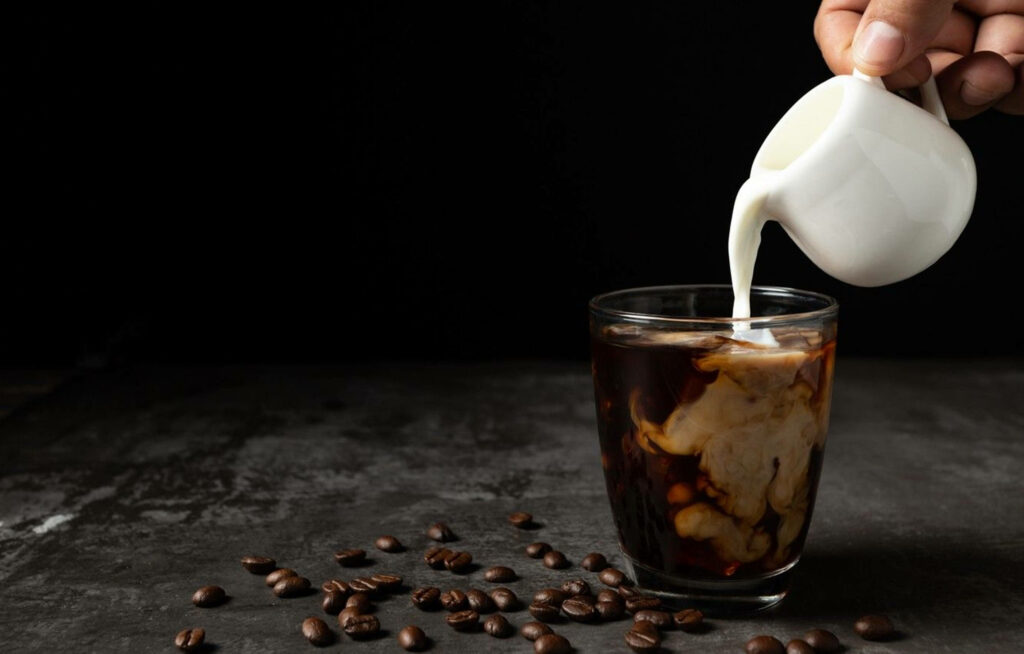 Elegant Coffee Wallpaper: Creamy Mix on Rustic Surface with Beans