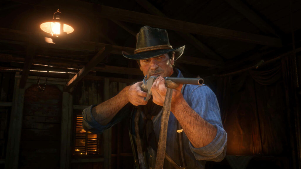 Arthur Morgan loading double barrel shotgun in dim cabin Red Dead Redemption 2 wallpaper