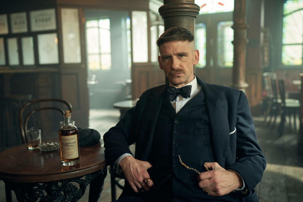 Exquisite Whiskey Time: Alluring Peaky Blinders Arthur Shelby Drinking in a Mesmerizing 8k Wallpaper