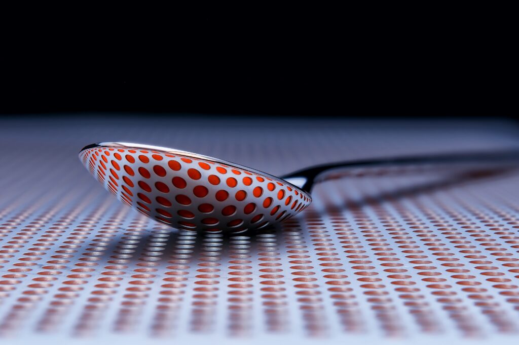 Artistic 3D Spoon Wallpaper: Red & White Circle Design Background