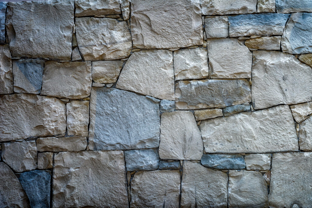 Organic Ambiance: A Close-up Asymmetrical Stone Wall Mosaic Desktop Wallpaper
