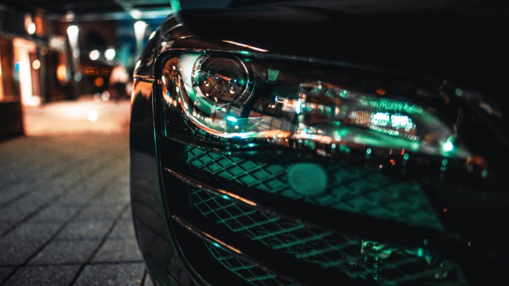 Stylish Nighttime Car Headlight & Bumper Close-Up Wallpaper