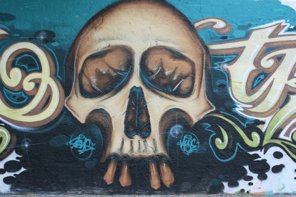 Ethereal Expression: A Captivating Graffiti Wall Unveiling Artistic Skull in HD Wallpaper