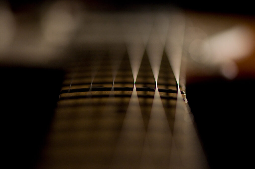 Artistic Guitar Fretboard Wallpaper: Macro Shot with Soft Glow