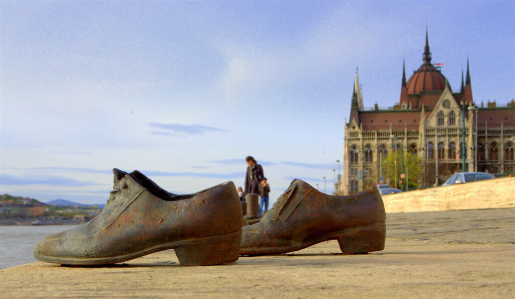 Striking Waterfront Shoes with Historic Building & Serene Sky Wallpaper