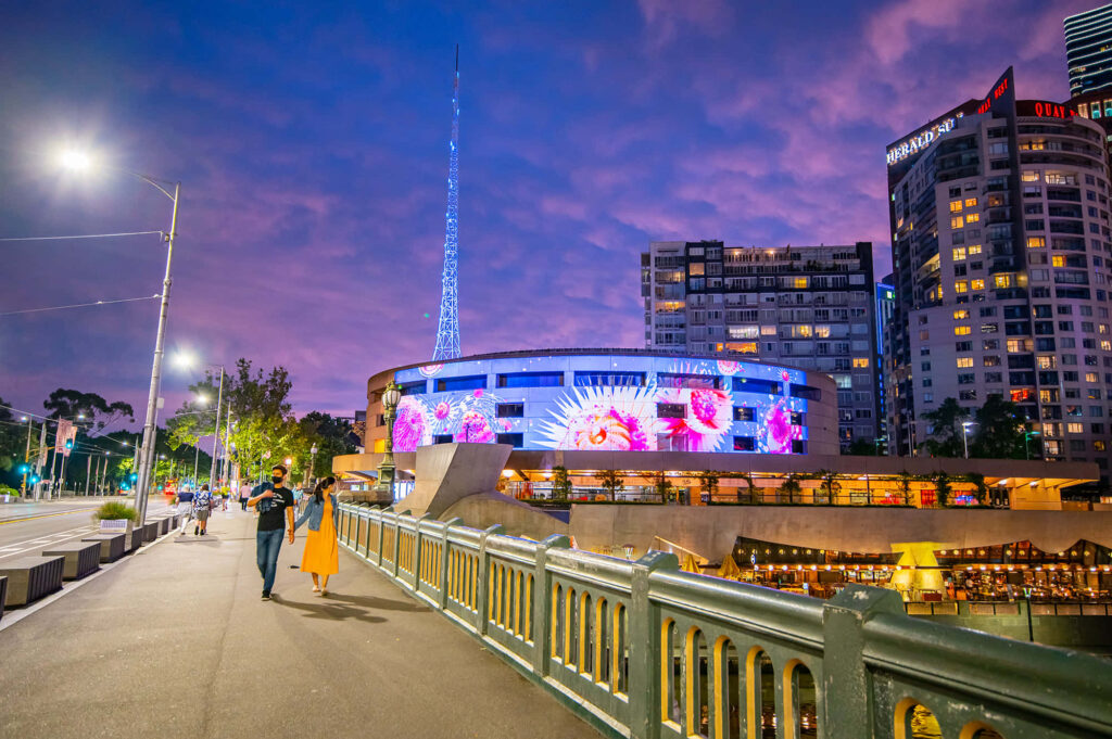 Arts Centre Melbourne evening cityscape with colorful lights purple sky riverside path walk Wallpaper