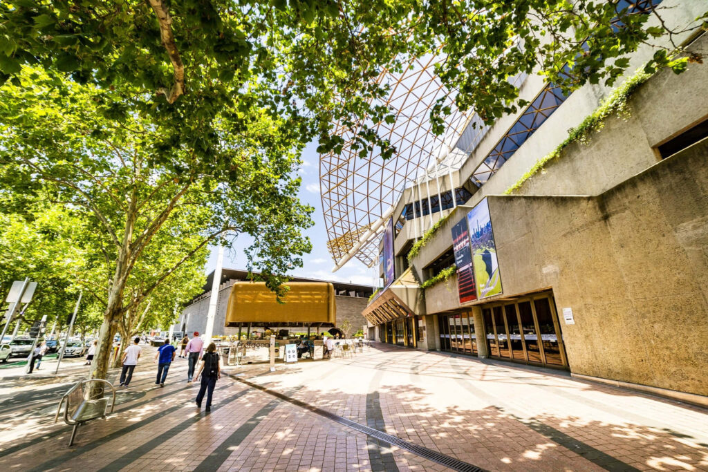 Arts Centre Melbourne exterior with modern architecture vibrant atmosphere and lush green trees Wallpaper