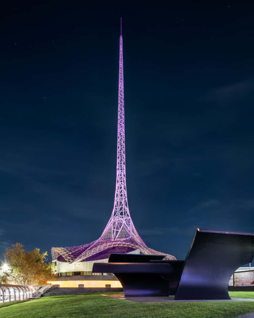 Arts Centre Melbourne Spire glowing vibrant purple at night showcasing striking architecture Wallpaper