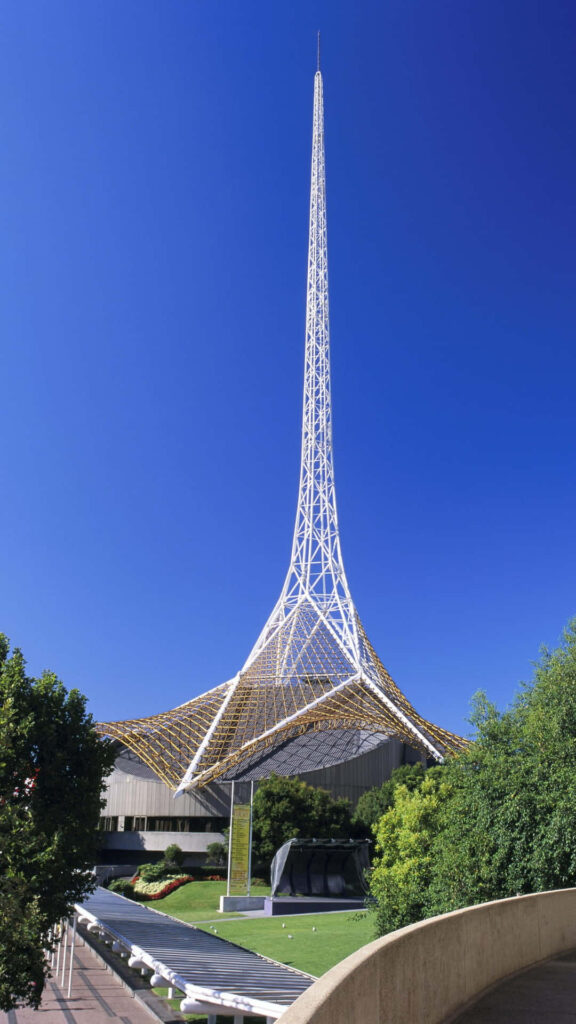 Arts Centre Melbourne Spire against blue sky with green trees modern lattice architecture wallpaper