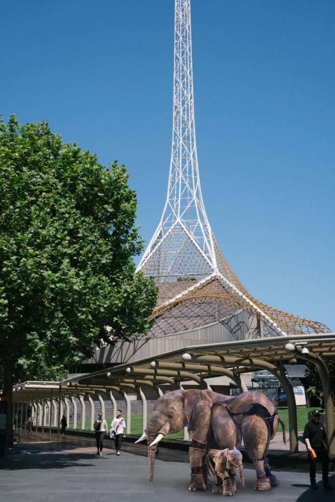 Arts Centre Melbourne spire with lifelike elephant statues under clear blue sky wallpaper background
