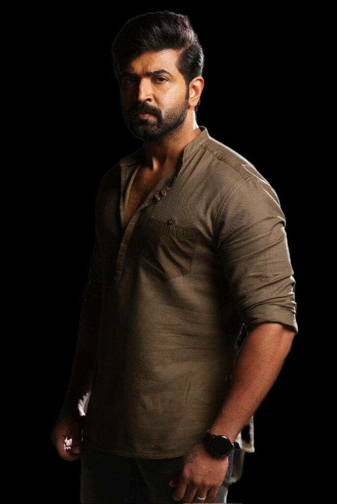 Arun Vijay intense portrait wallpaper showing strong confident expression on dark background