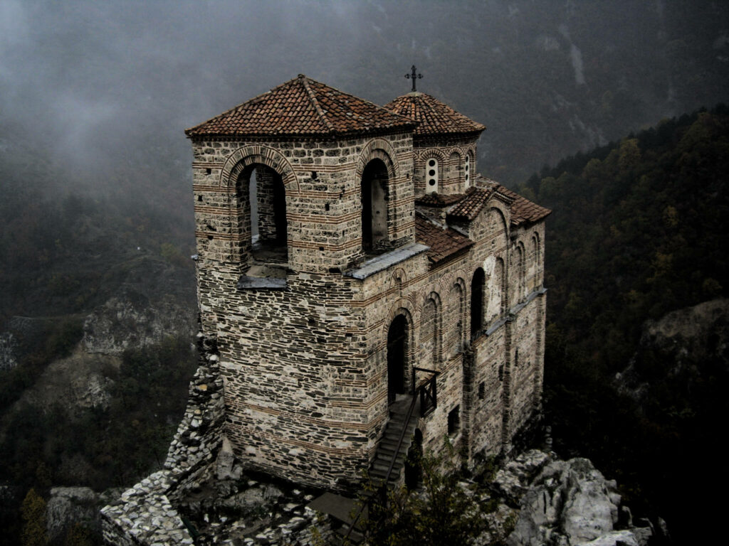 Asens Fortress on rocky hill Bulgaria misty mountains dense forest historic stone architecture Wallpaper