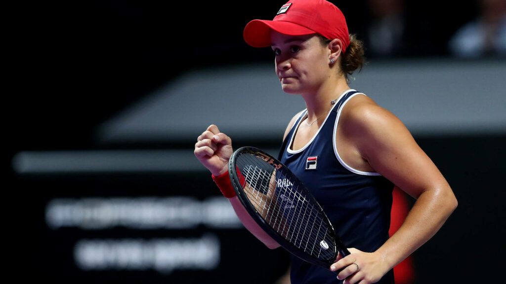 Ashleigh Barty focused gripping tennis racket during intense competitive match wallpaper background
