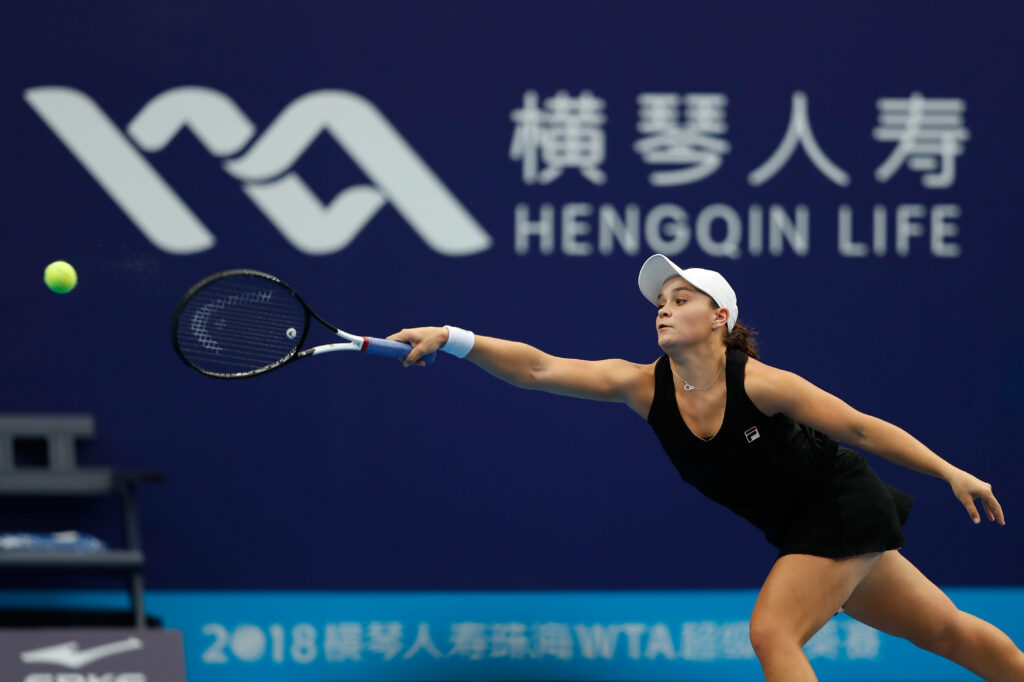 Ashleigh Barty stretches to return a shot during intense Shenzhen Open tennis match action Wallpaper