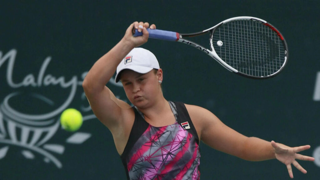 Ashleigh Barty focused tennis player ready to hit incoming ball during competitive match wallpaper