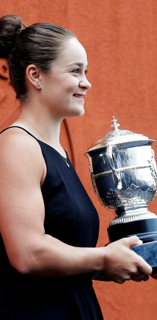 Ashleigh Barty side profile smiling holding silver trophy orange background tennis champion Wallpaper