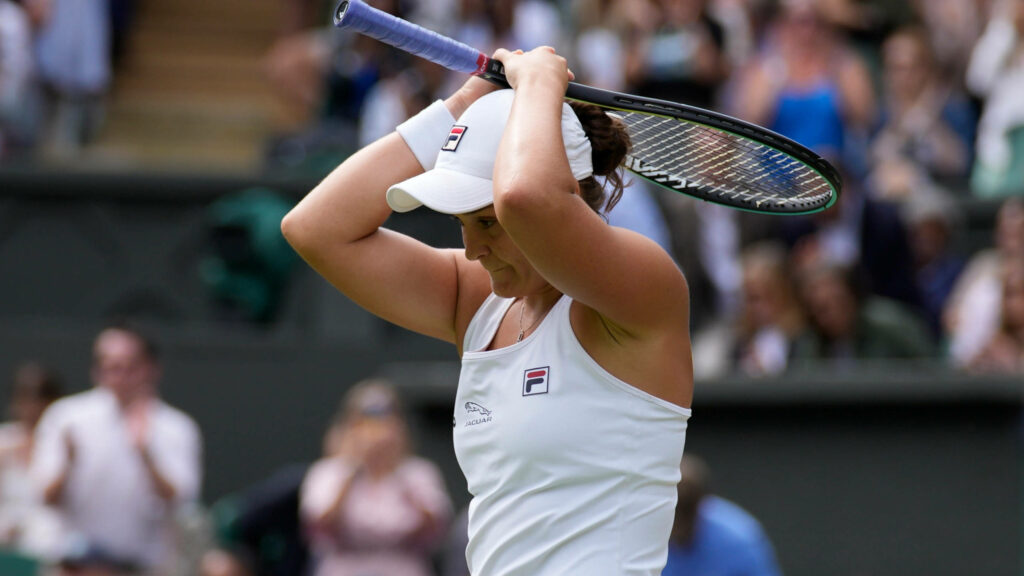 Ashleigh Barty focused holding tennis racket above head showing determination in match wallpaper