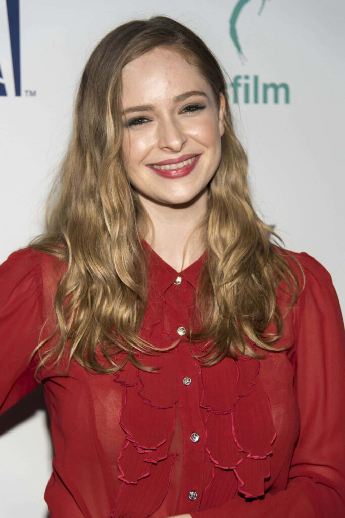 Ashleigh Cummings in vibrant red blouse glowing with warm smile elegant photoshoot wallpaper