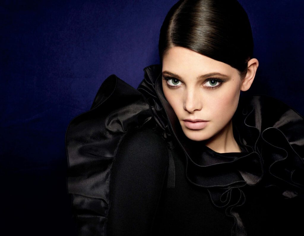 Ashley Greene elegant portrait in black ruffled outfit against deep blue background wallpaper