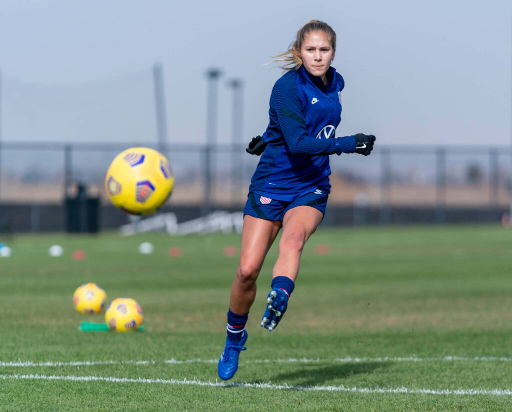 Ashley Sanchez focused soccer training action dynamic motion blurred ball wallpaper background