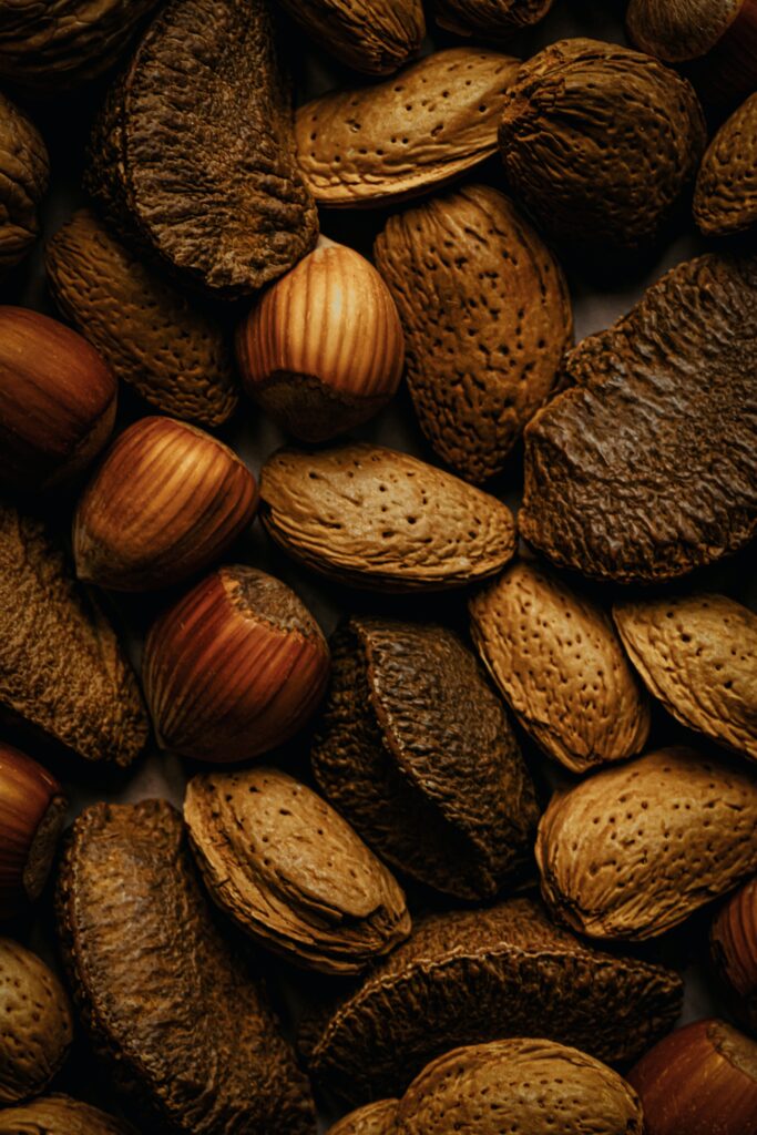 Close-Up Wallpaper of Assorted Brown Nuts: Natural Textures & Tones