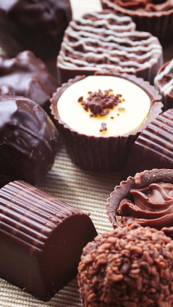 Sweet Delight: Close-Up of Assorted Chocolates for Wallpaper Background