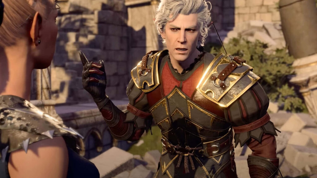 Astarion from Baldurs Gate in ornate armor animatedly speaking amid ancient stone ruins wallpaper