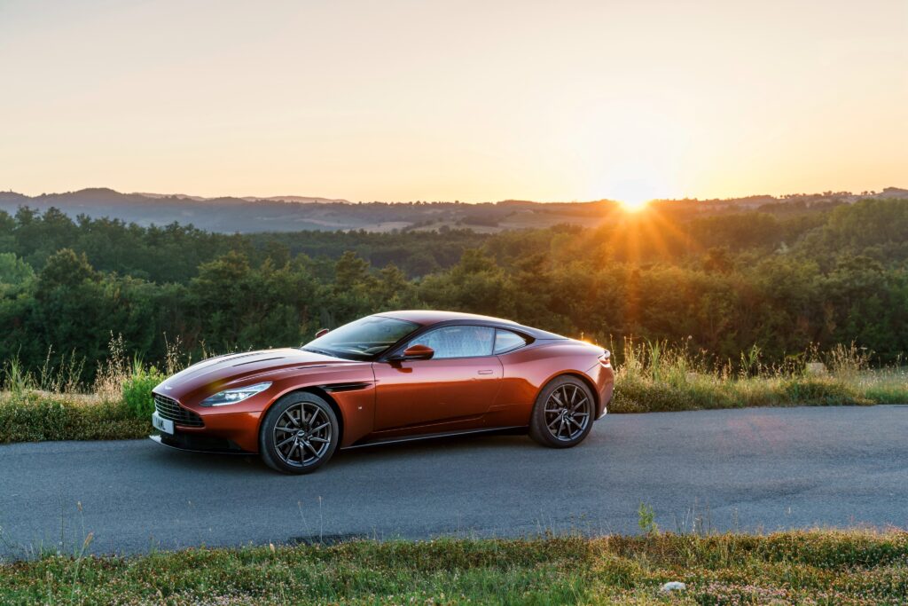 Sleek Aston Martin DB11 with Sunset Background Wallpaper