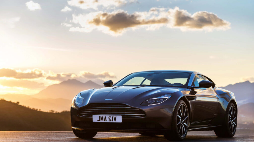 Sleek Aston Martin DB11 Wallpaper: Elegance in Sunset & Mountains
