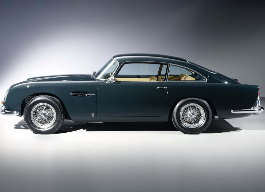 Aston Martin DB5 classic car elegantly illuminated highlighting timeless design and luxury details Wallpaper