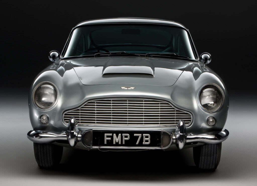 Aston Martin DB5 front view silver vintage sports car classic elegant grille dark background wallpaper