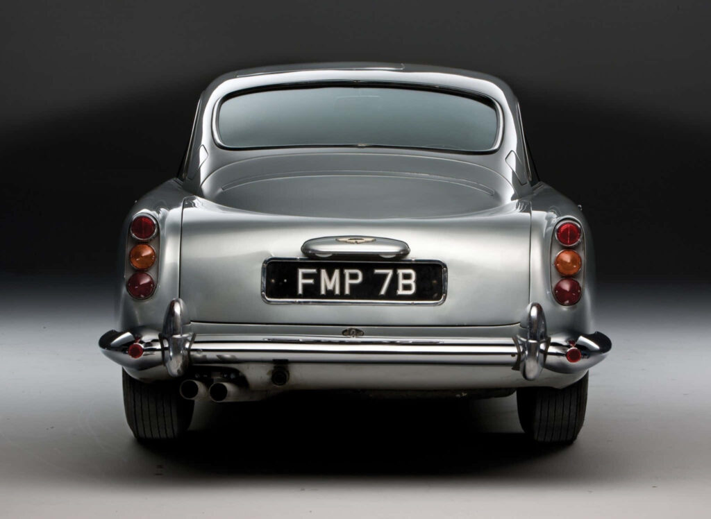 Rear view of classic Aston Martin DB5 showcasing timeless British grand tourer elegance wallpaper