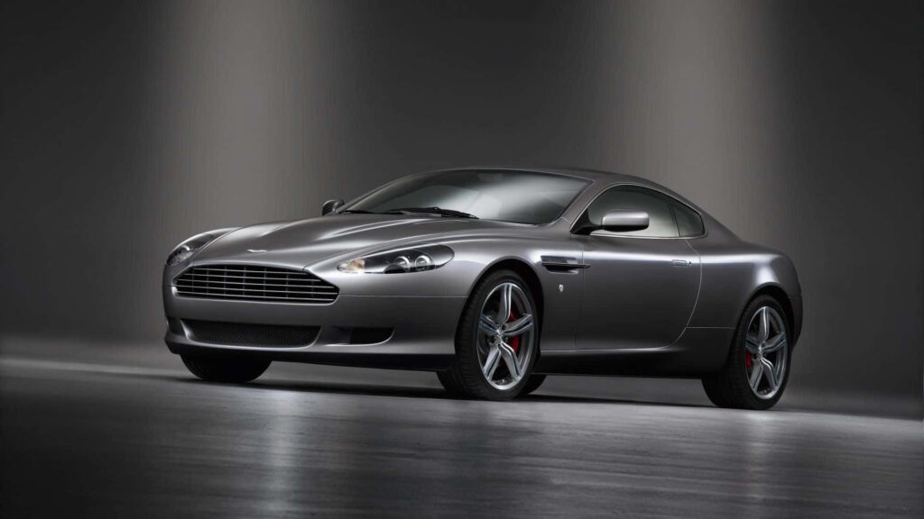 Aston Martin DB9 sports car in sleek studio showcasing elegance performance wallpaper background