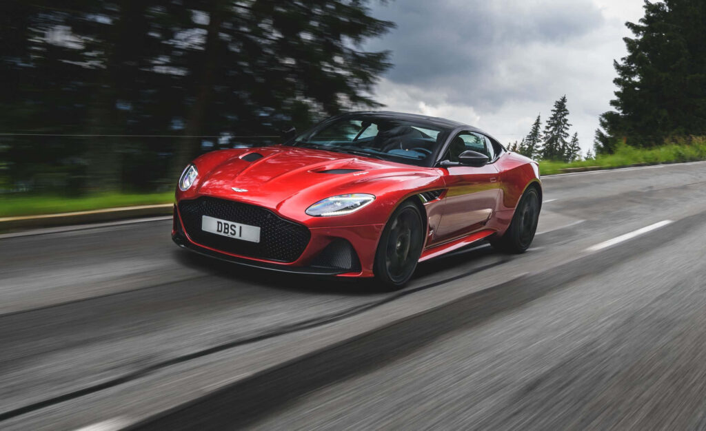 Dynamic Aston Martin DBS Superleggera Wallpaper: Luxury on Scenic Roads