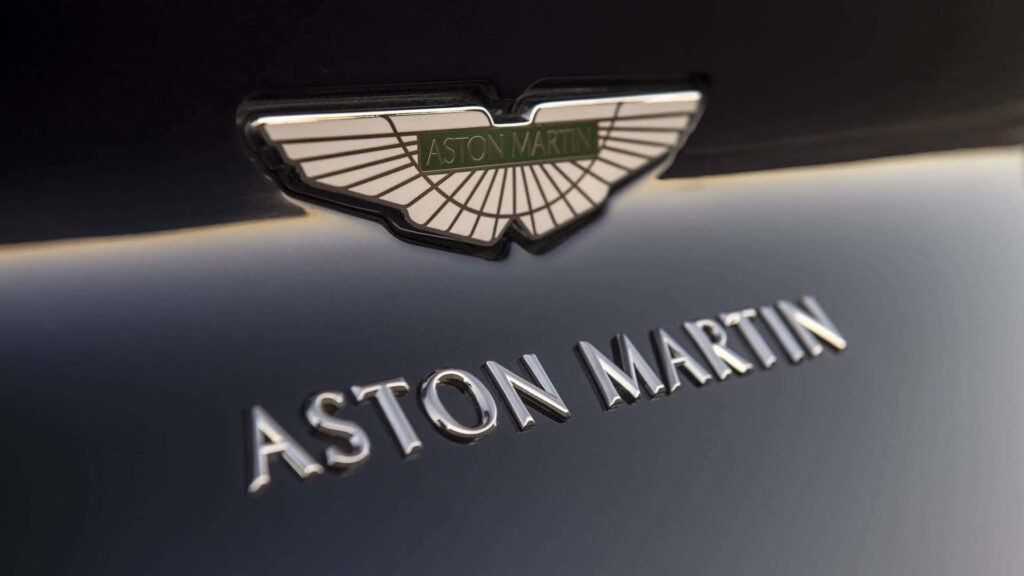 Elegant Aston Martin Logo Wallpaper: Power & Luxury Background