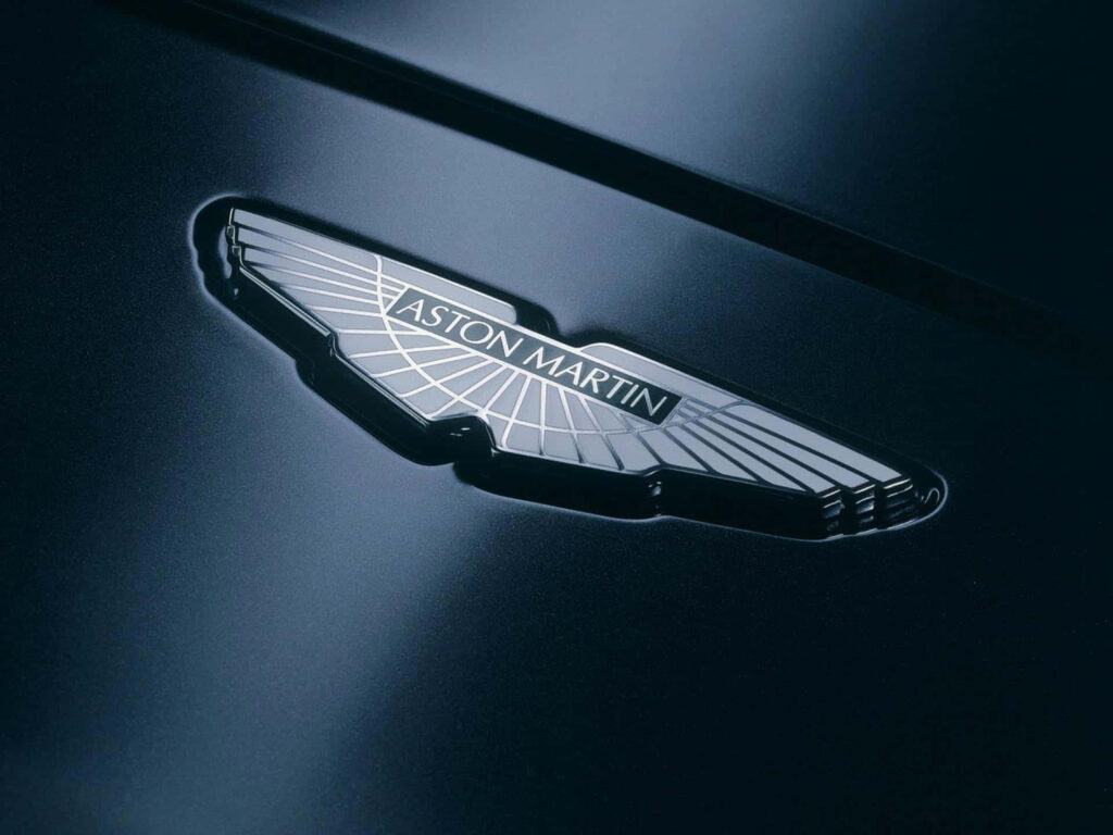 Aston Martin Logo Wallpaper: Sleek Elegance on Polished Background