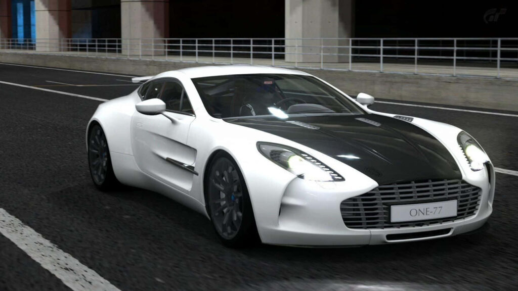 Aston Martin One-77 speeding through city at night with sleek design and powerful presence wallpaper