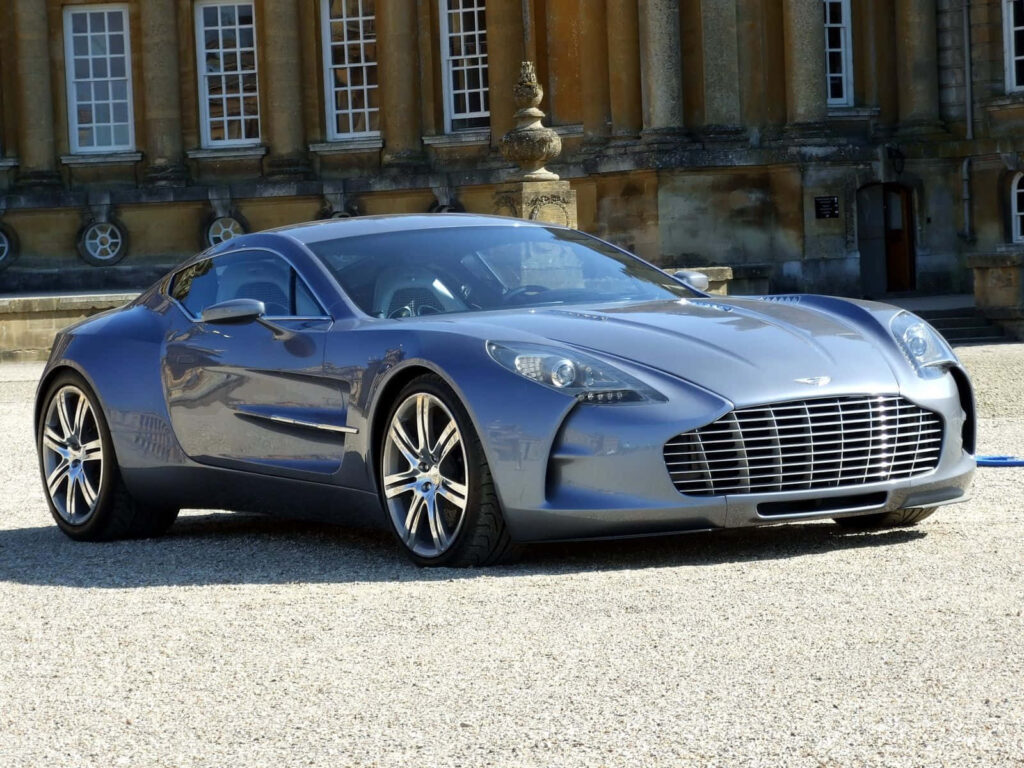 Aston Martin One 77 luxury car sleek silhouette front grille elegant architectural backdrop wallpaper
