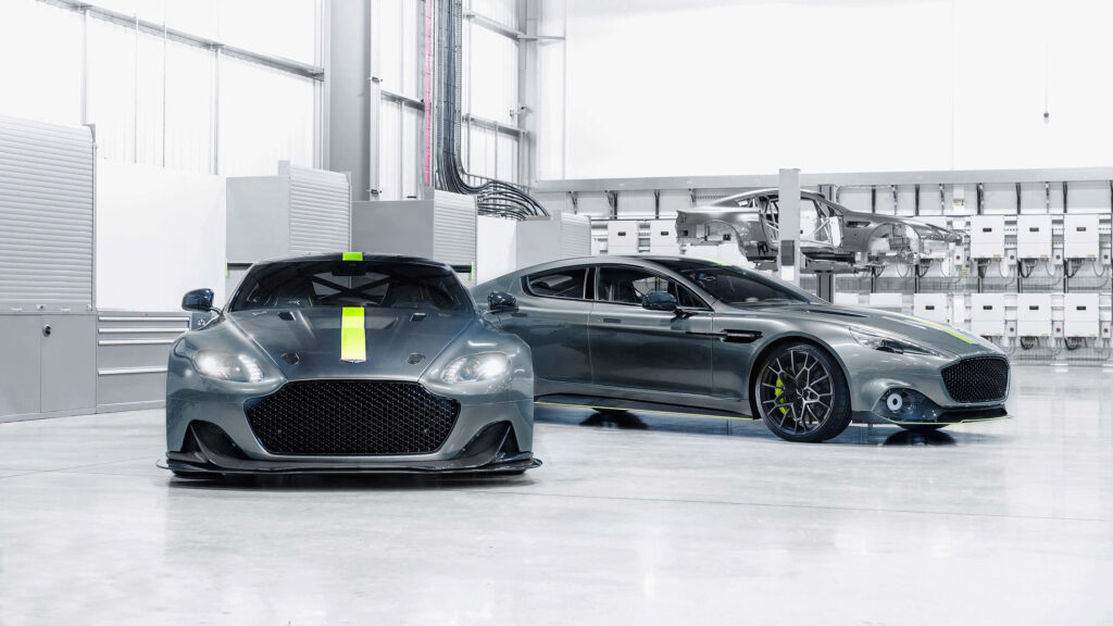 Two sleek Aston Martin Rapide S cars in a modern high-tech garage showcasing elegance and power Wallpaper