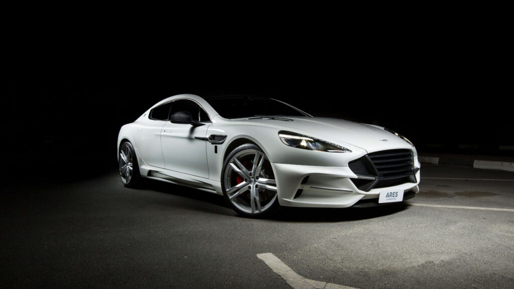 Aston Martin Rapide S sports car illuminated on empty road showcasing sleek elegant design Wallpaper
