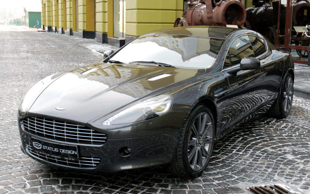 Aston Martin Rapide S luxury car sleek design on cobblestone street high performance wallpaper