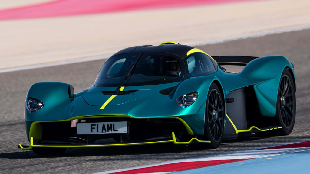 Aston Martin V12 green sports car racing on track showcasing sleek aerodynamic design wallpaper