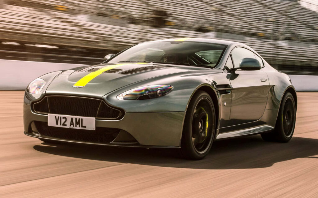 Aston Martin V12 Vantage racing on track sleek design powerful performance wallpaper background